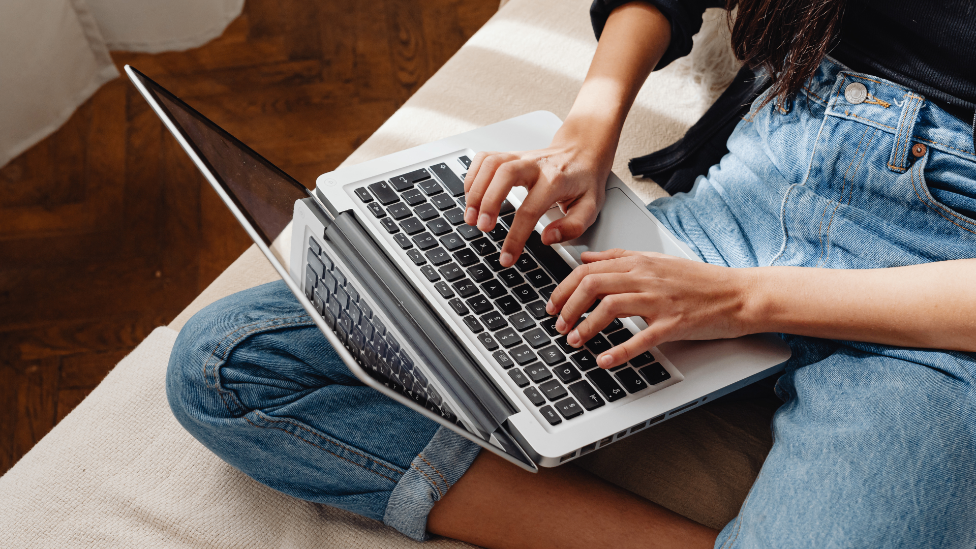 Person typing on a laptop to represent digital audience activity