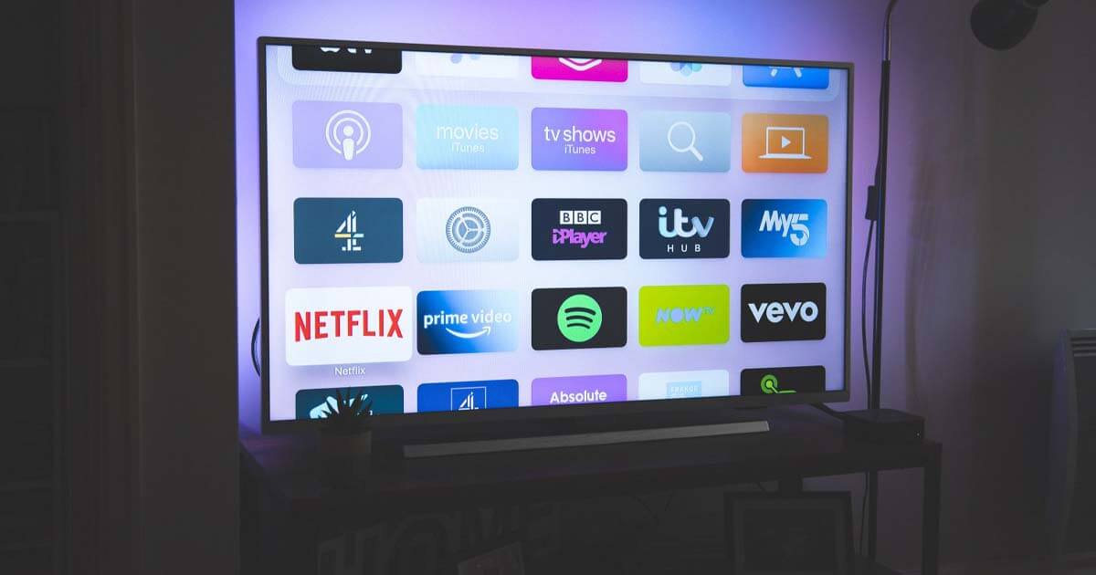 A connected TV (CTV) featuring apps for Netflix, Hulu, Prime Video, Spotify and other streaming services on screen