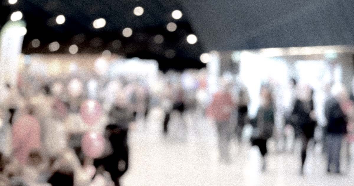 A timelapse shot of a busy shopping mall with blurred people, hiding their identities