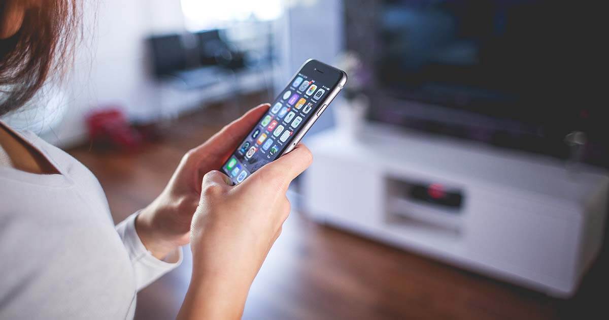 Close up photo of a woman using an Apple iPhone